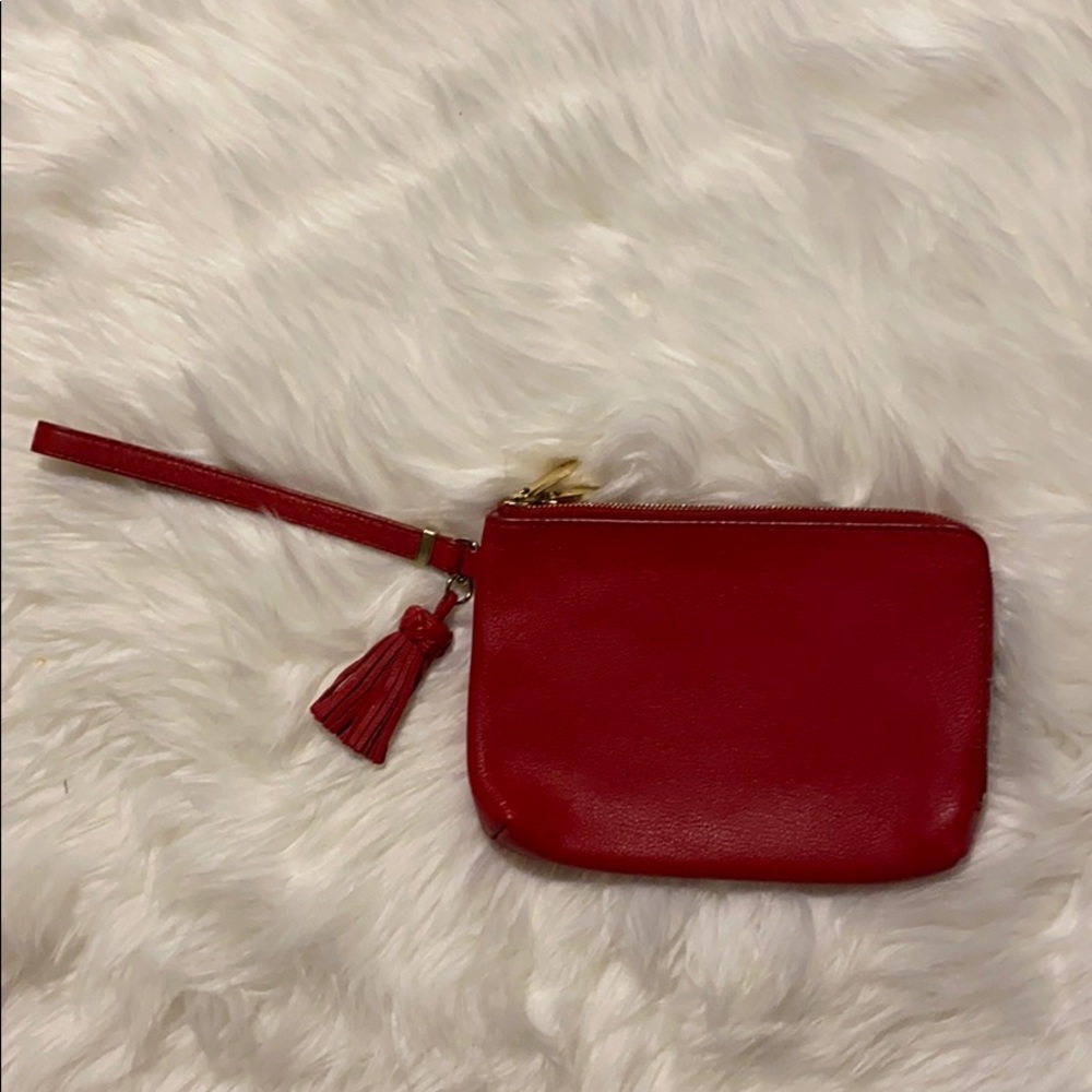 Gently used red leather wristlet with tassel